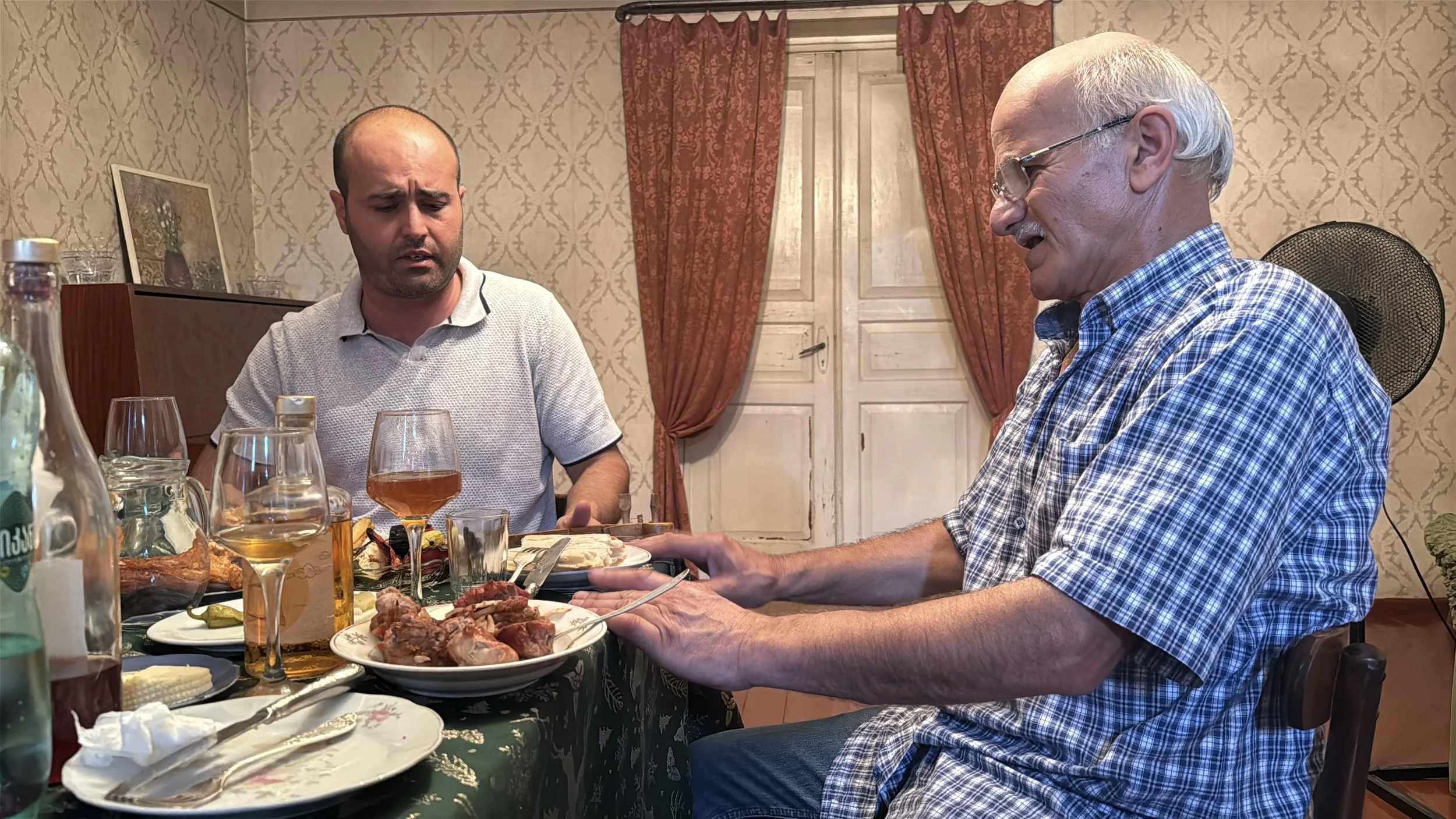 Two Georgian men sing at a family feast
