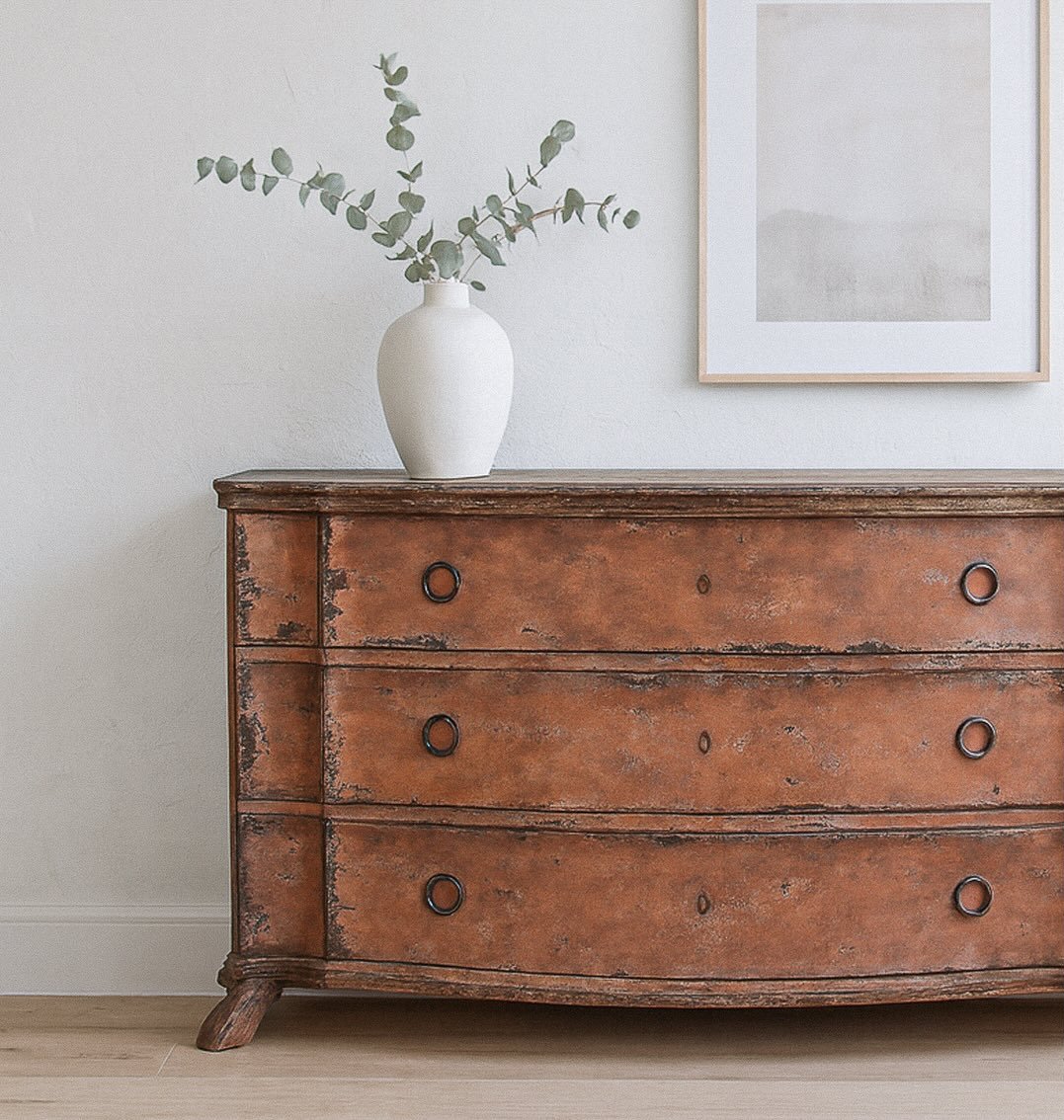 Old-world romance with a modern edge. The Italian Serpentine Commode in Carnelian/Anthracite Gesso Finish brings a rich, lived-in patina to its graceful curves&mdash;an instant heirloom for any room. Sculptural, storied, and quietly bold, it&rsquo;s 