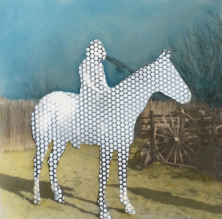  A figure on a horse made up of white dots. 