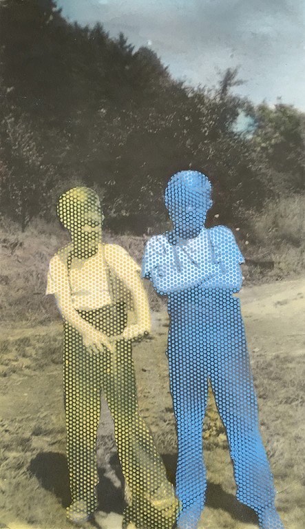  A boy made of yellow dots and a boy made of blue dots pose for the camera. 