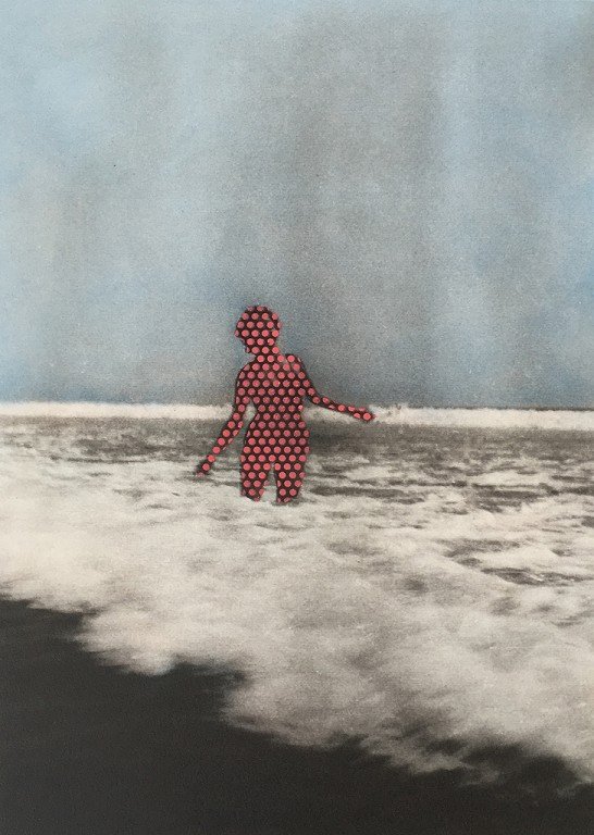  A woman in the ocean waves. She is covered in red dots. 