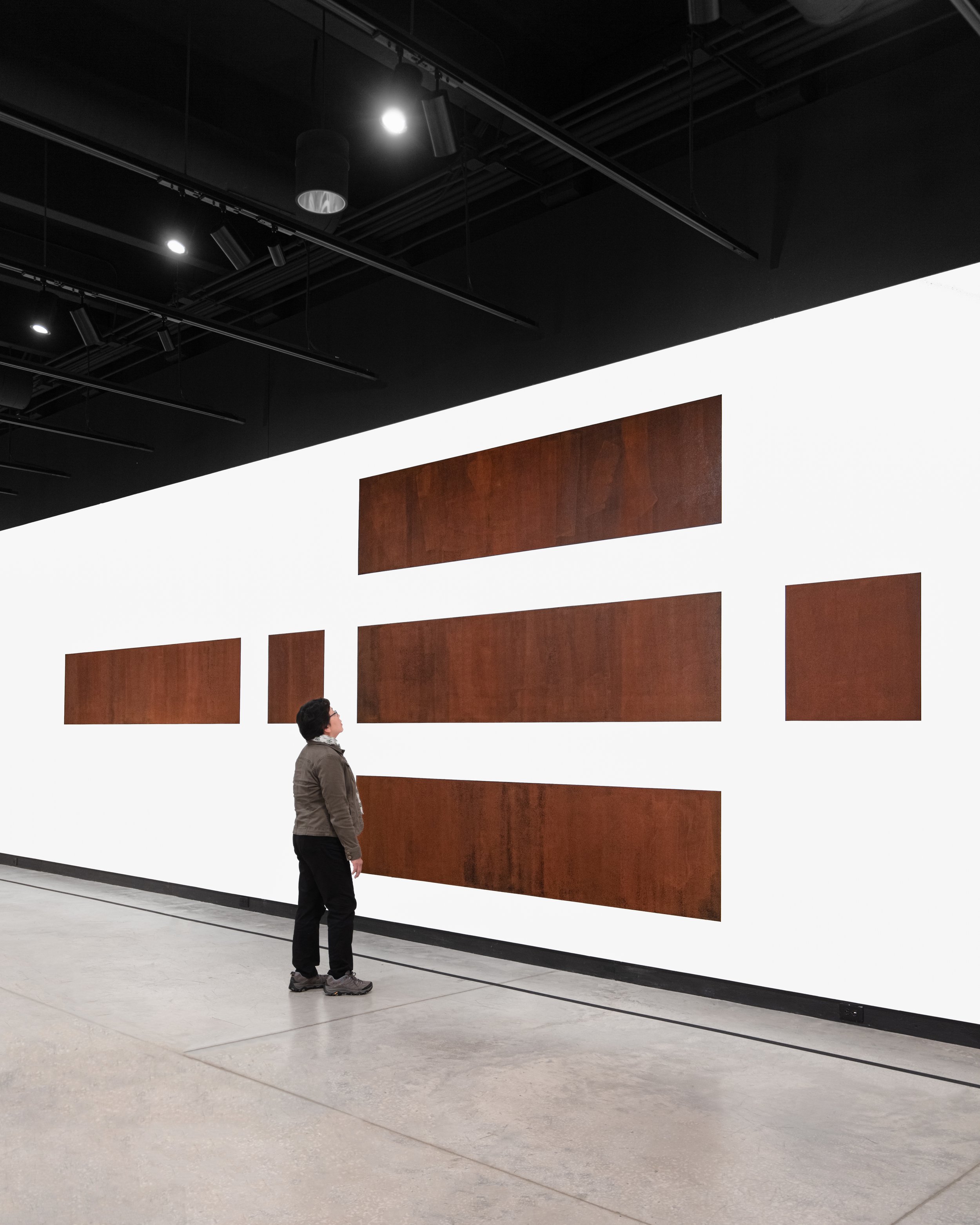  Individual admires “Rust in Peace” artwork. A depiction of each side of a box that would hold a nuclear weapon. 