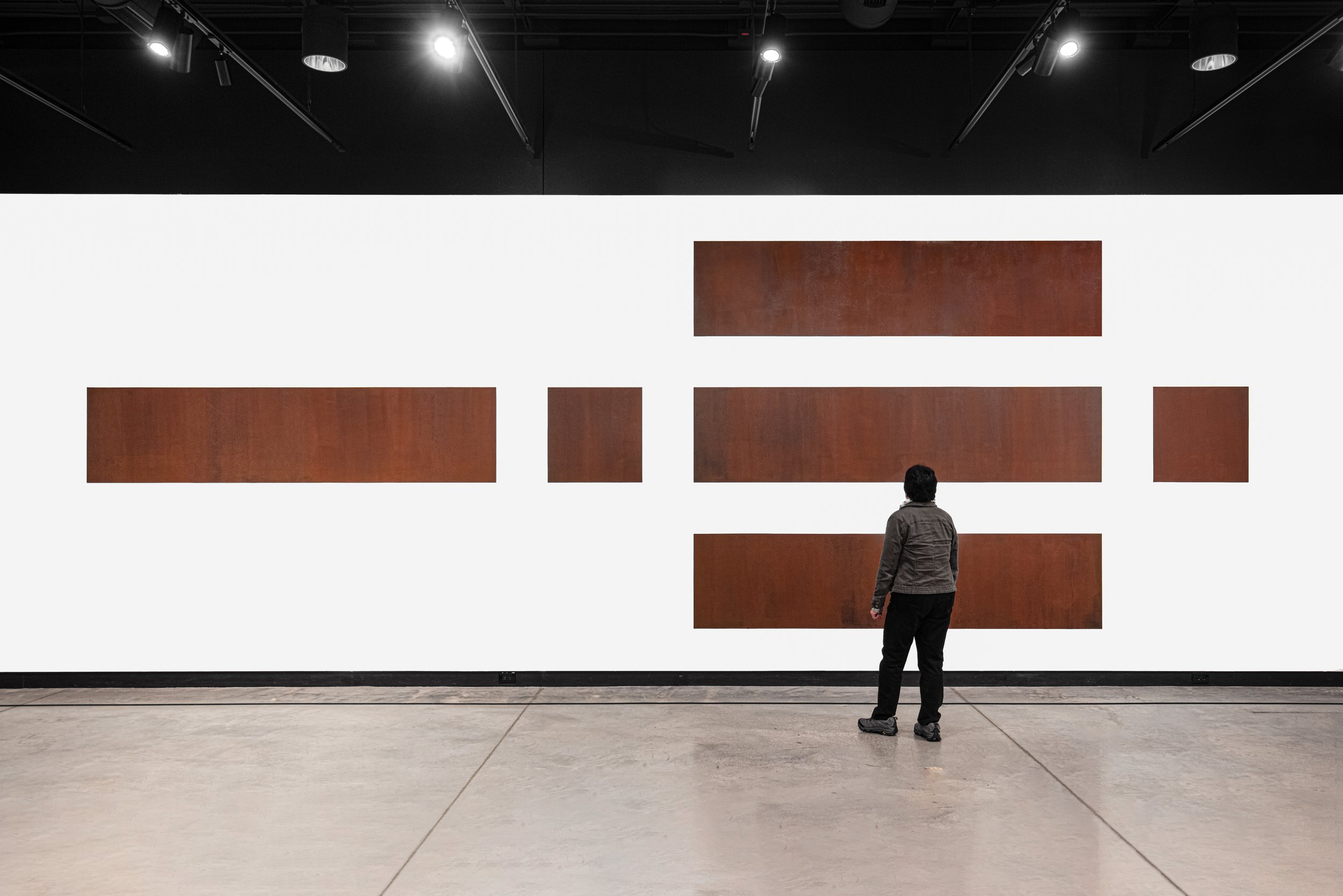 Individual admires “Rust in Peace” artwork. A depiction of each side of a box that would hold a nuclear weapon. 