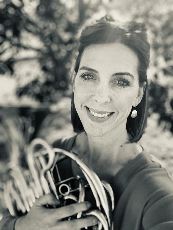 Sepia-styled portrait of Kristin Stearn holding a horn.