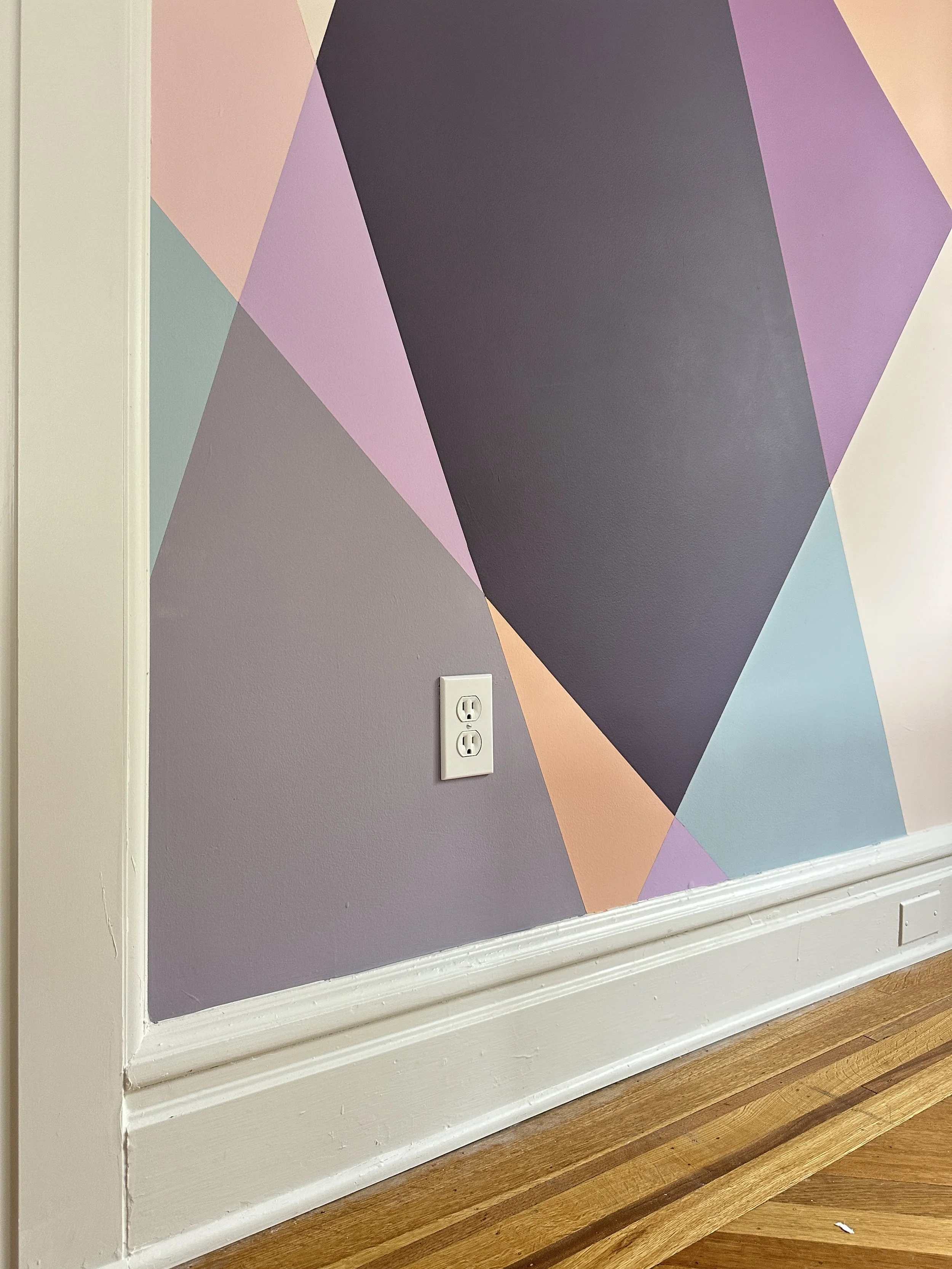 Hand-painted wraparound mural by Shapes For The People, bringing color and character to a teen bedroom retreat.