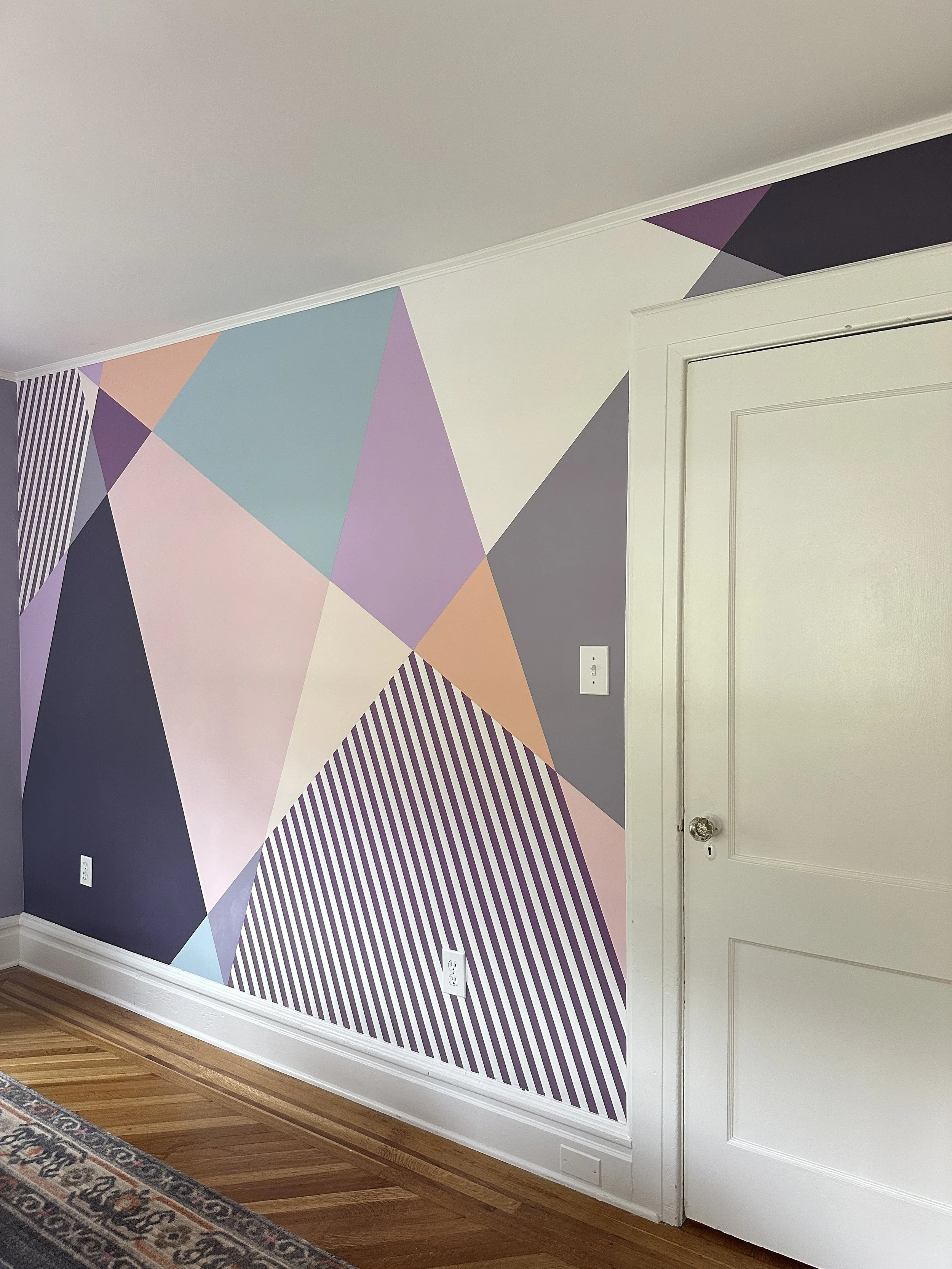 Custom bedroom mural with bold painted shapes, designed to make a teen’s room feel cozy, stylish and full of personality.