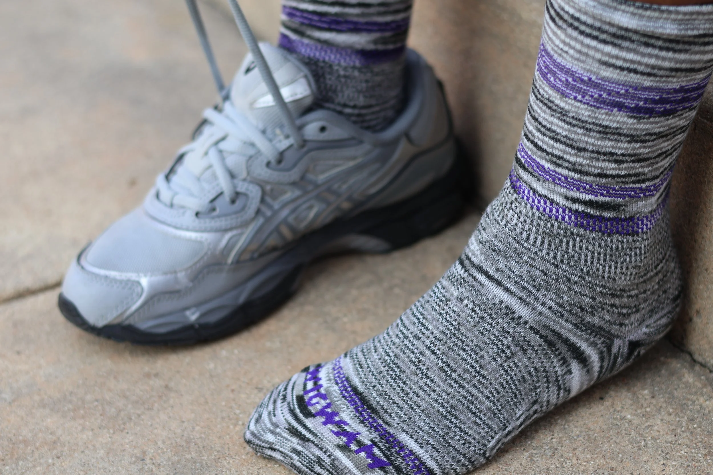 Homeschool mom adjusting sneakers while wearing Wigwam socks