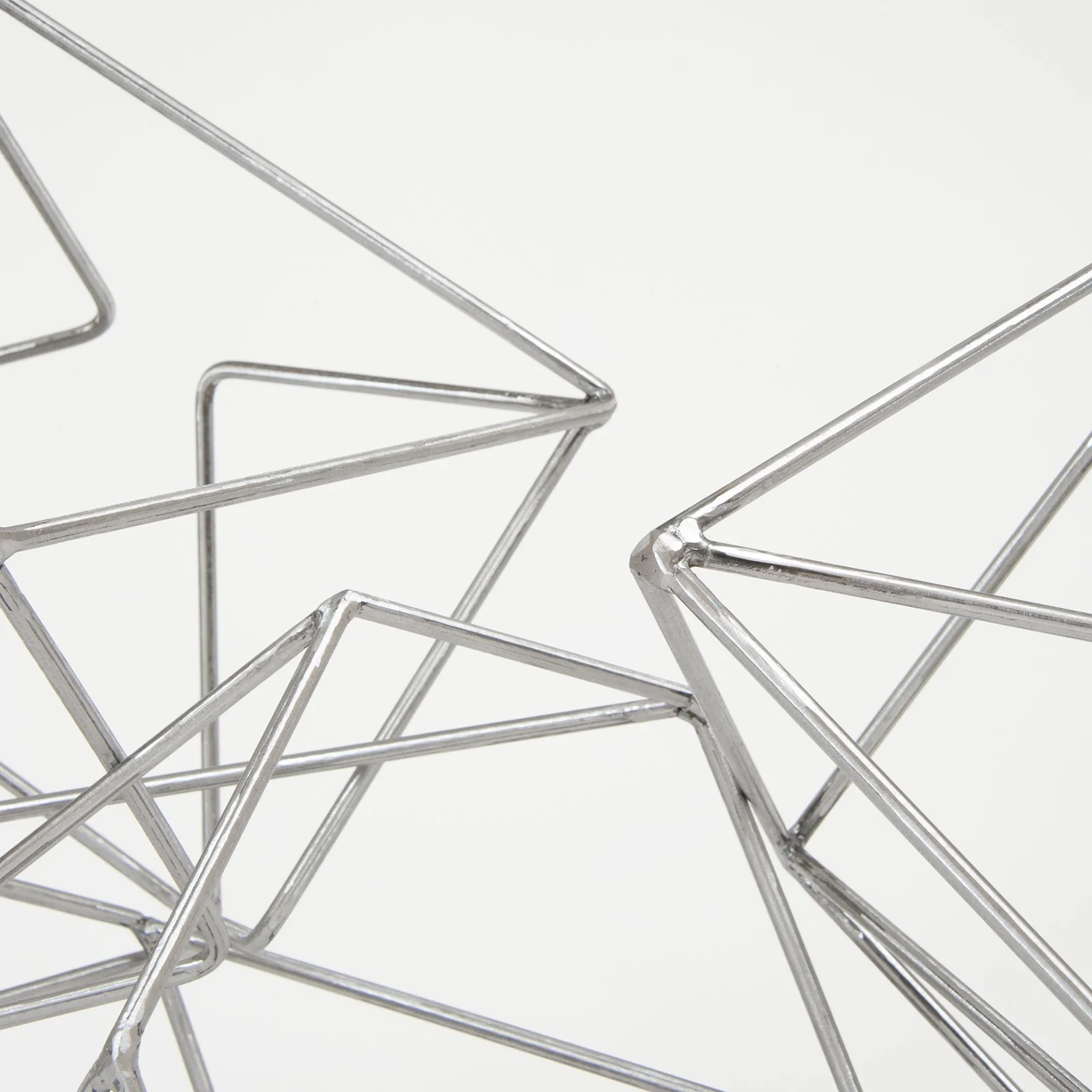 photograph of a close up of steel rod vessels intersecting