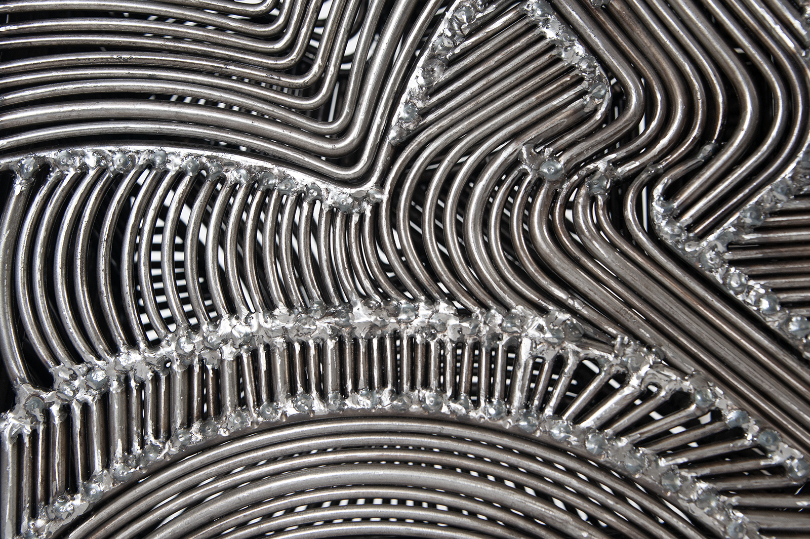 this is a detailed look at the abstract, bent metal sculpture, steps repeat