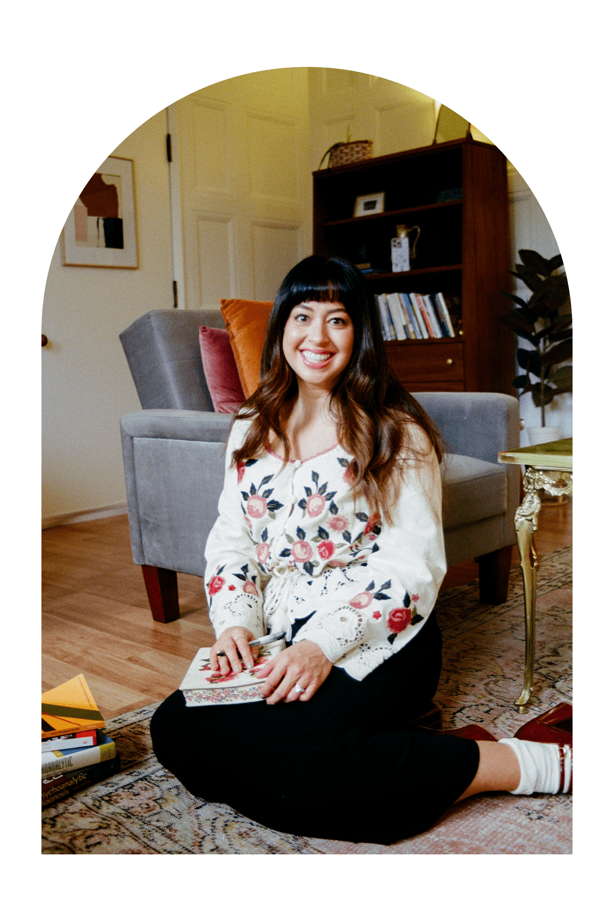 therapist on floor with journal and books