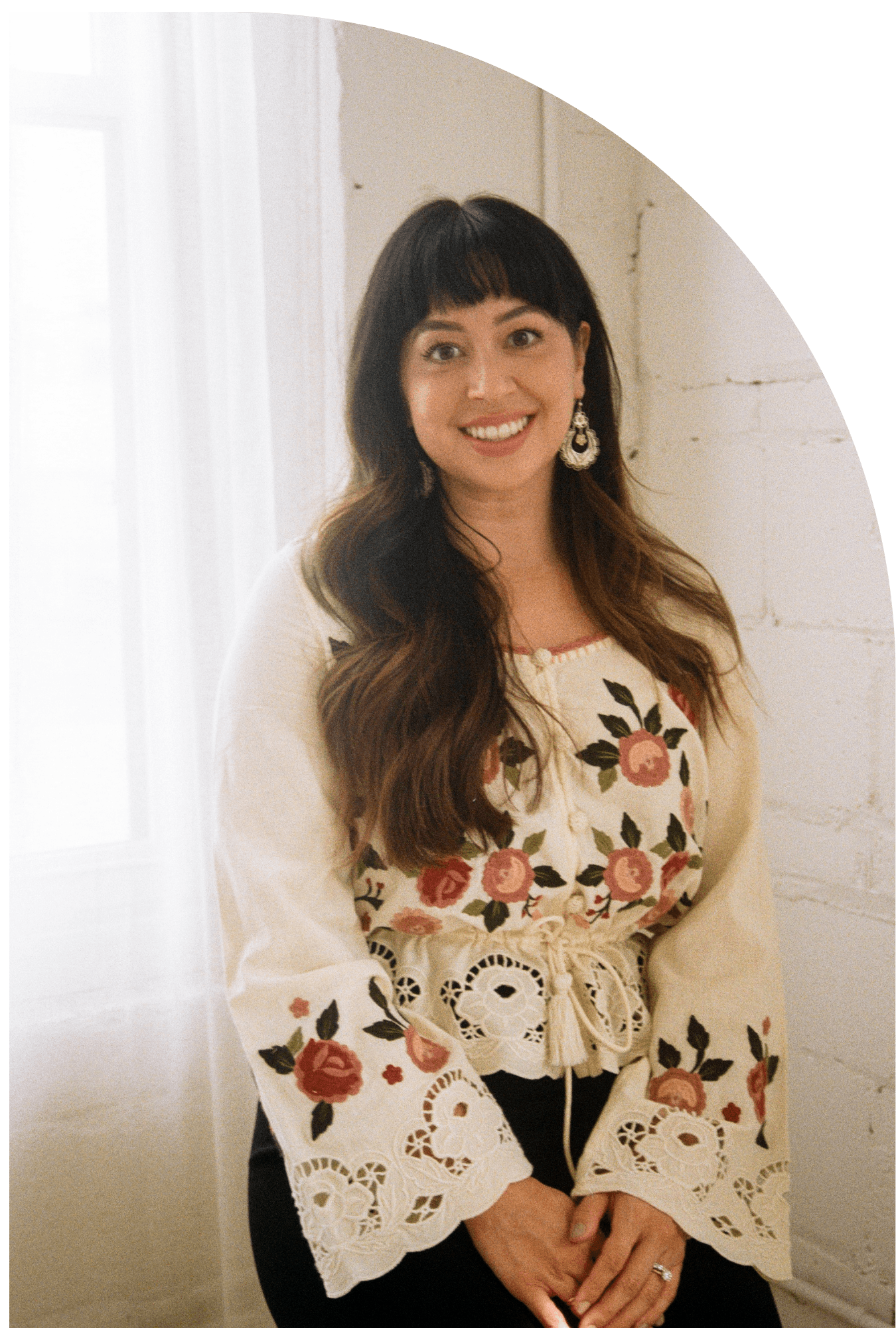 Amalia Miralrio looks at camera smiling on bench