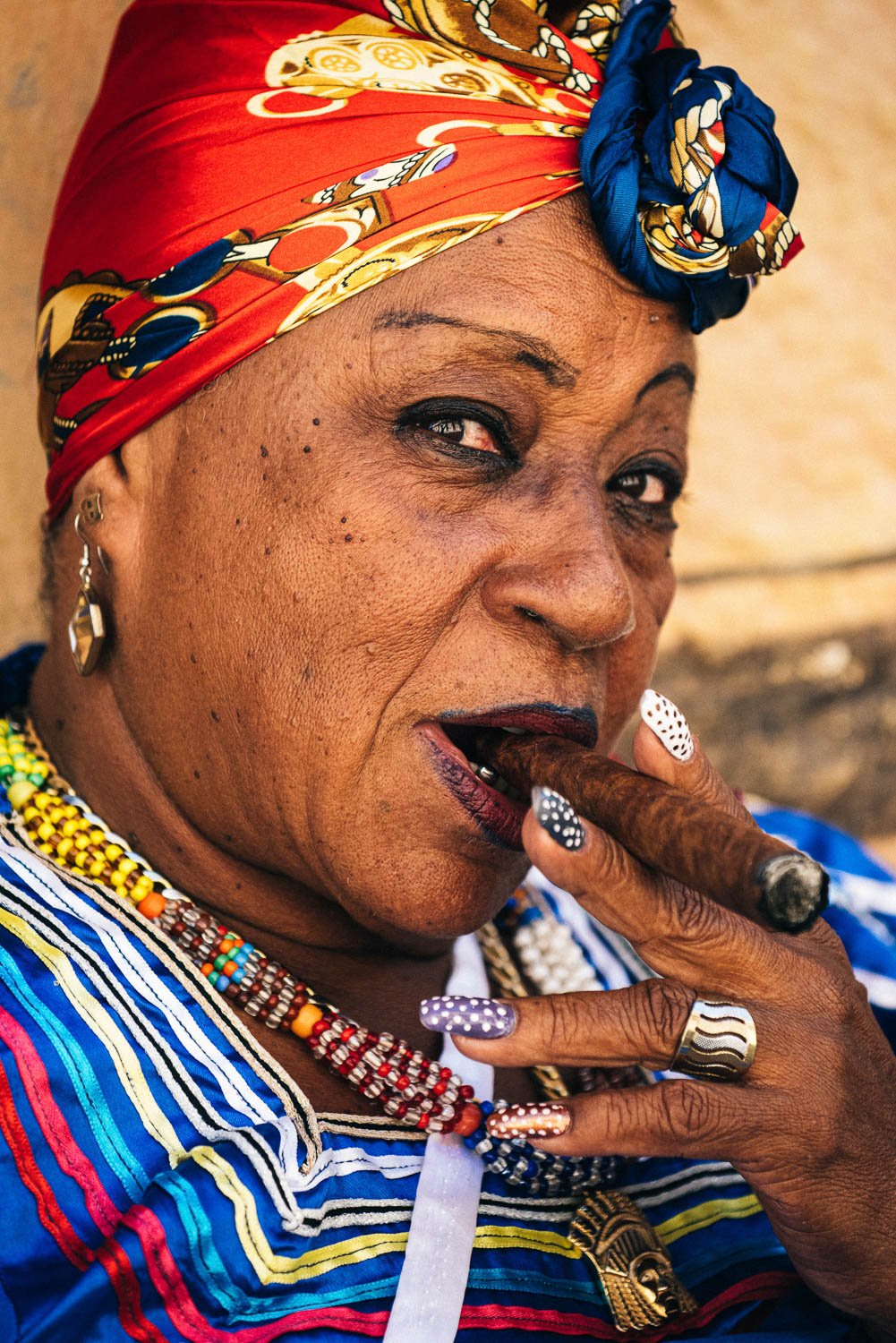 woman smoking cuban cigar - visiting Cuba from USA