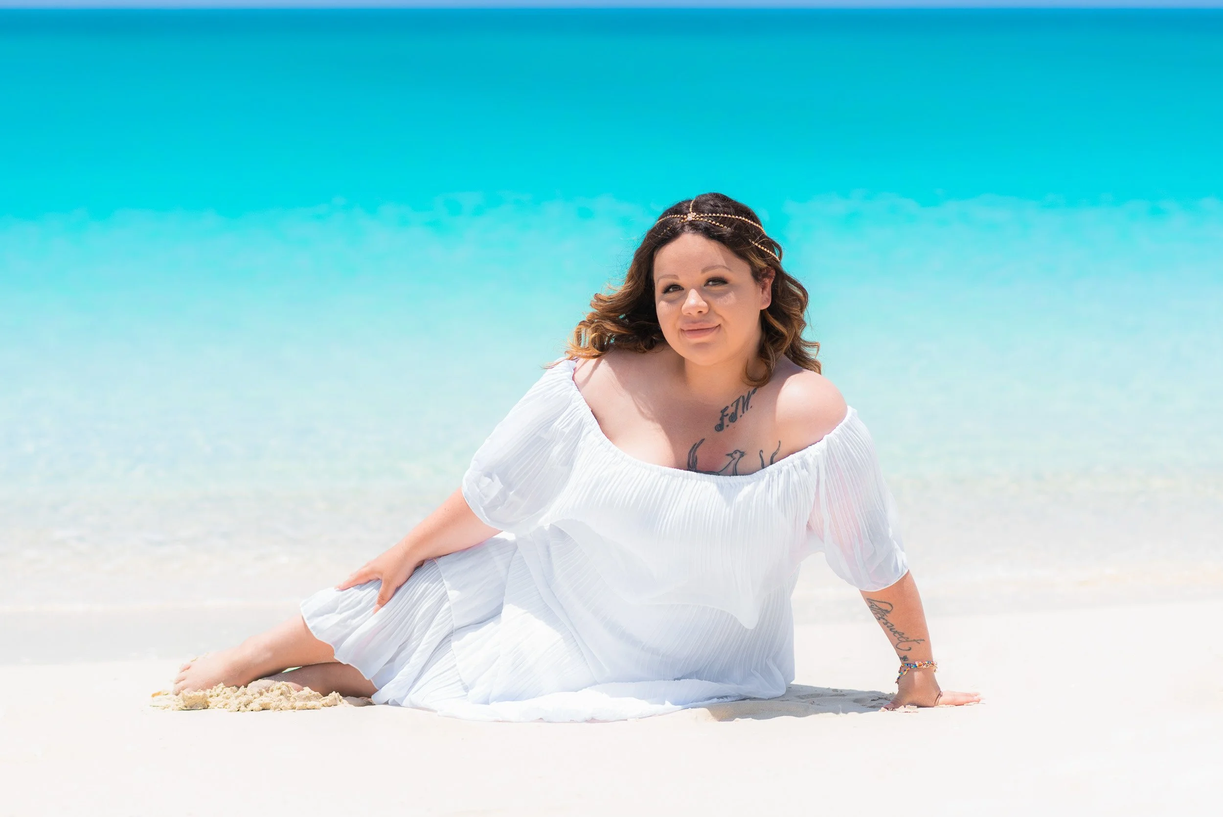 Woman sitting on Grace Bay Beach - Turks and Caicos What to Do