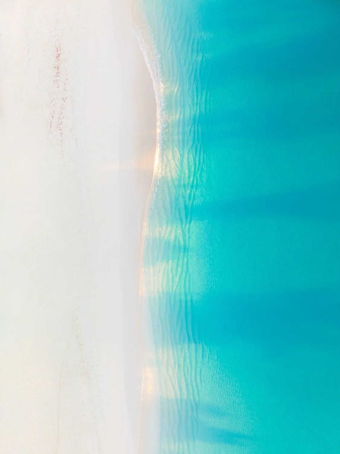 sunlight hitting beach waves - drone photography how to