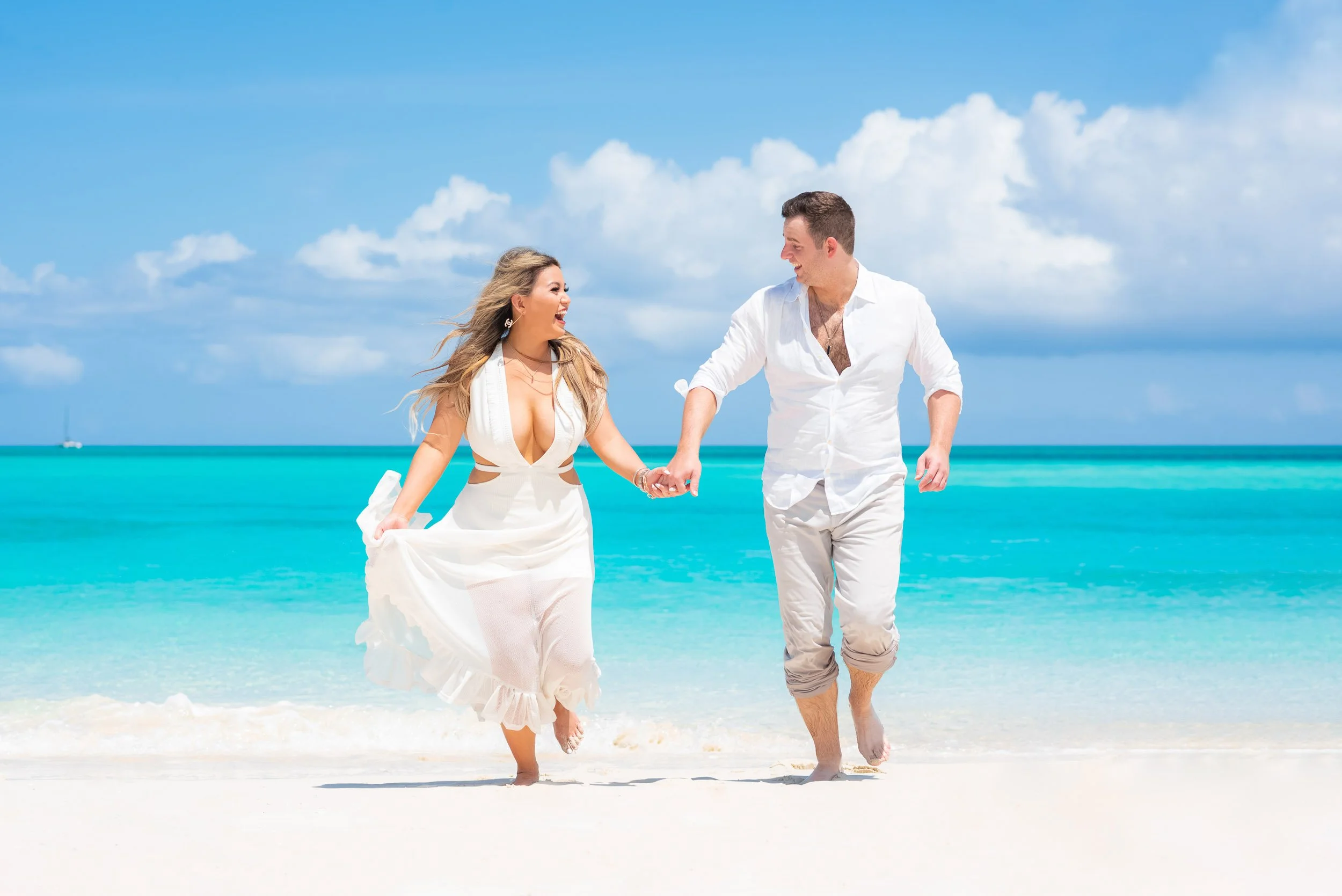 Couple running on Grace Bay Beach - Turks and Caicos What to Do
