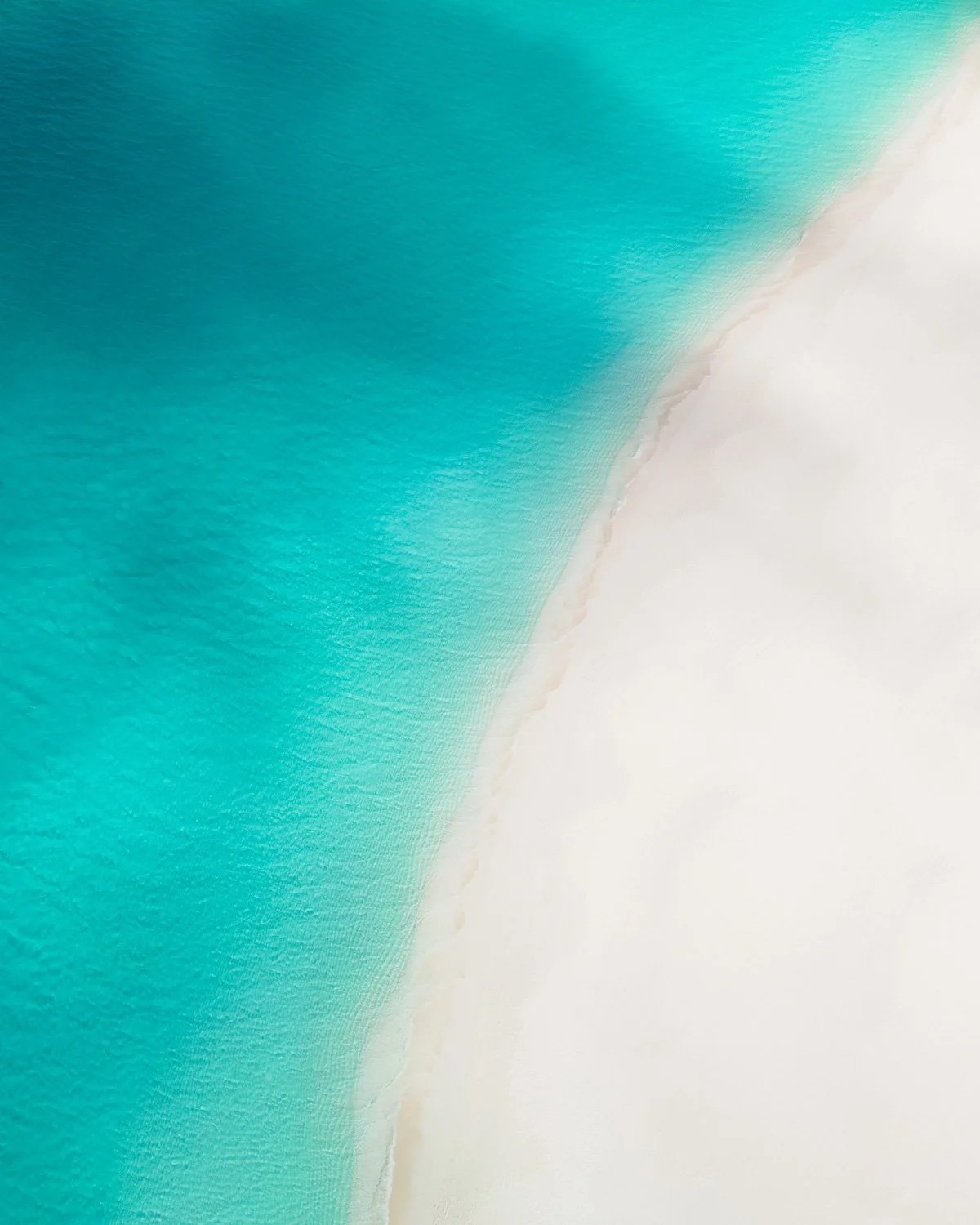 Cloud shadows on calm empty beach - drone photography how to