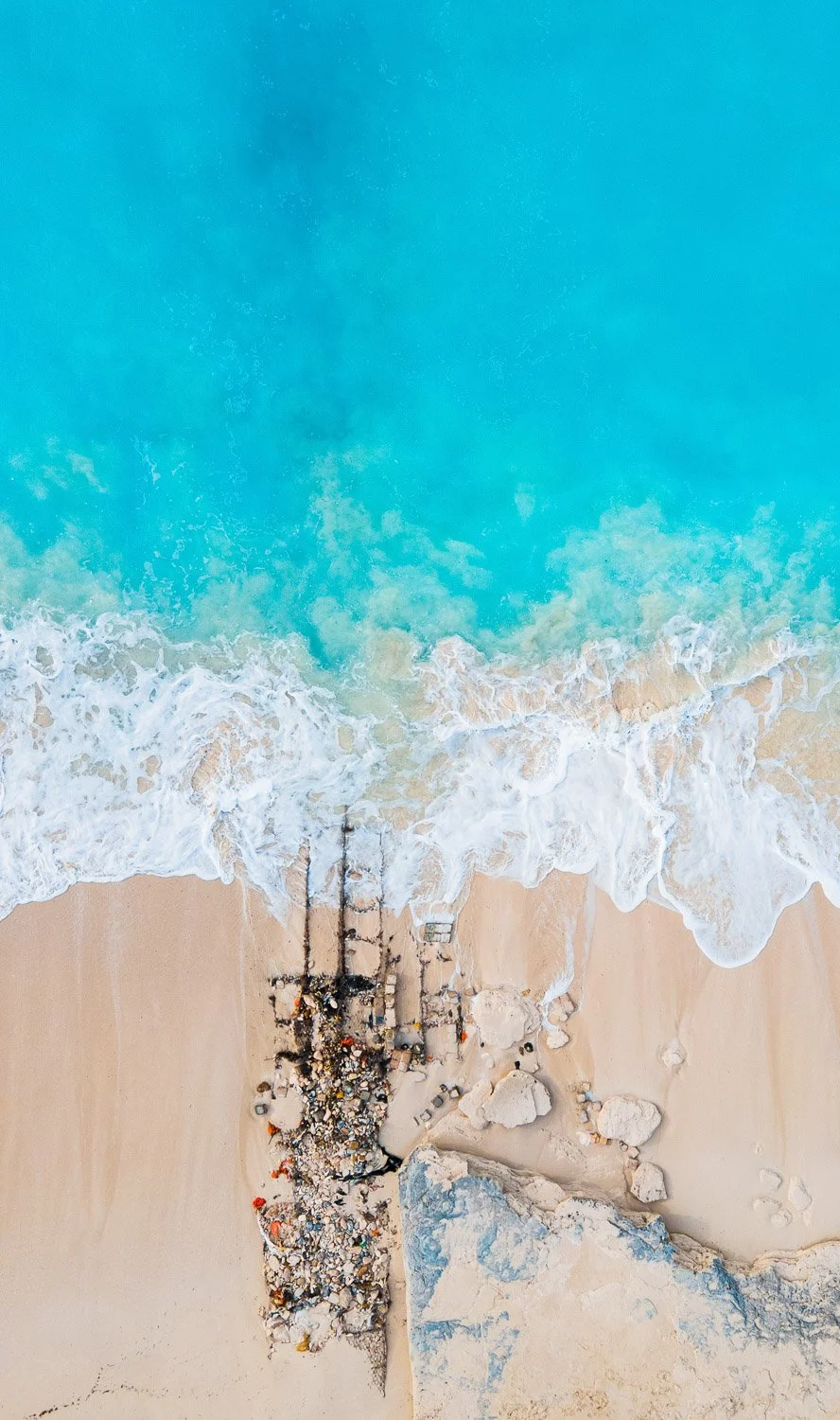 waves crashing on beach rocks - drone photography how to