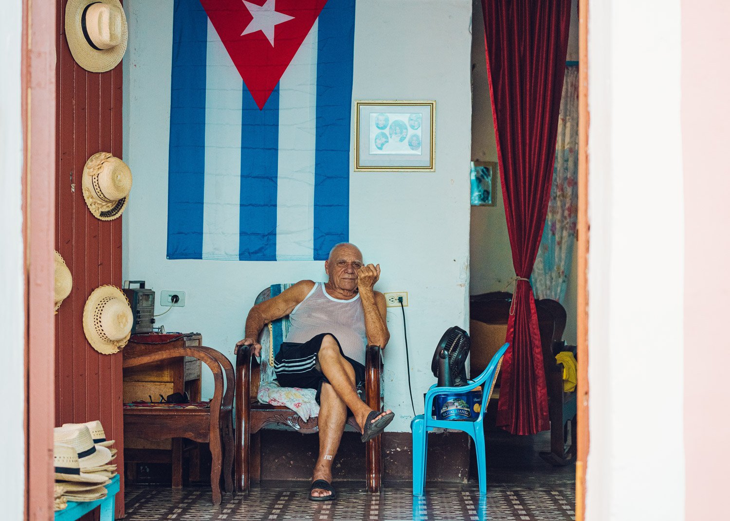 Cuban man selling hats in his home - visiting Cuba from USA