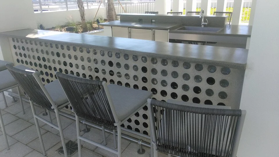 outdoor bar area with decorative concrete countertop and stools