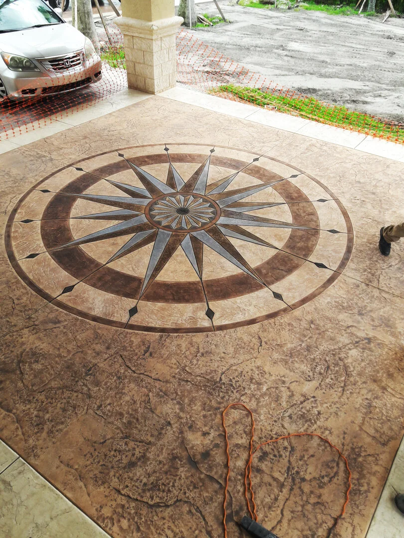 Stained concrete patio with compass rose design inset