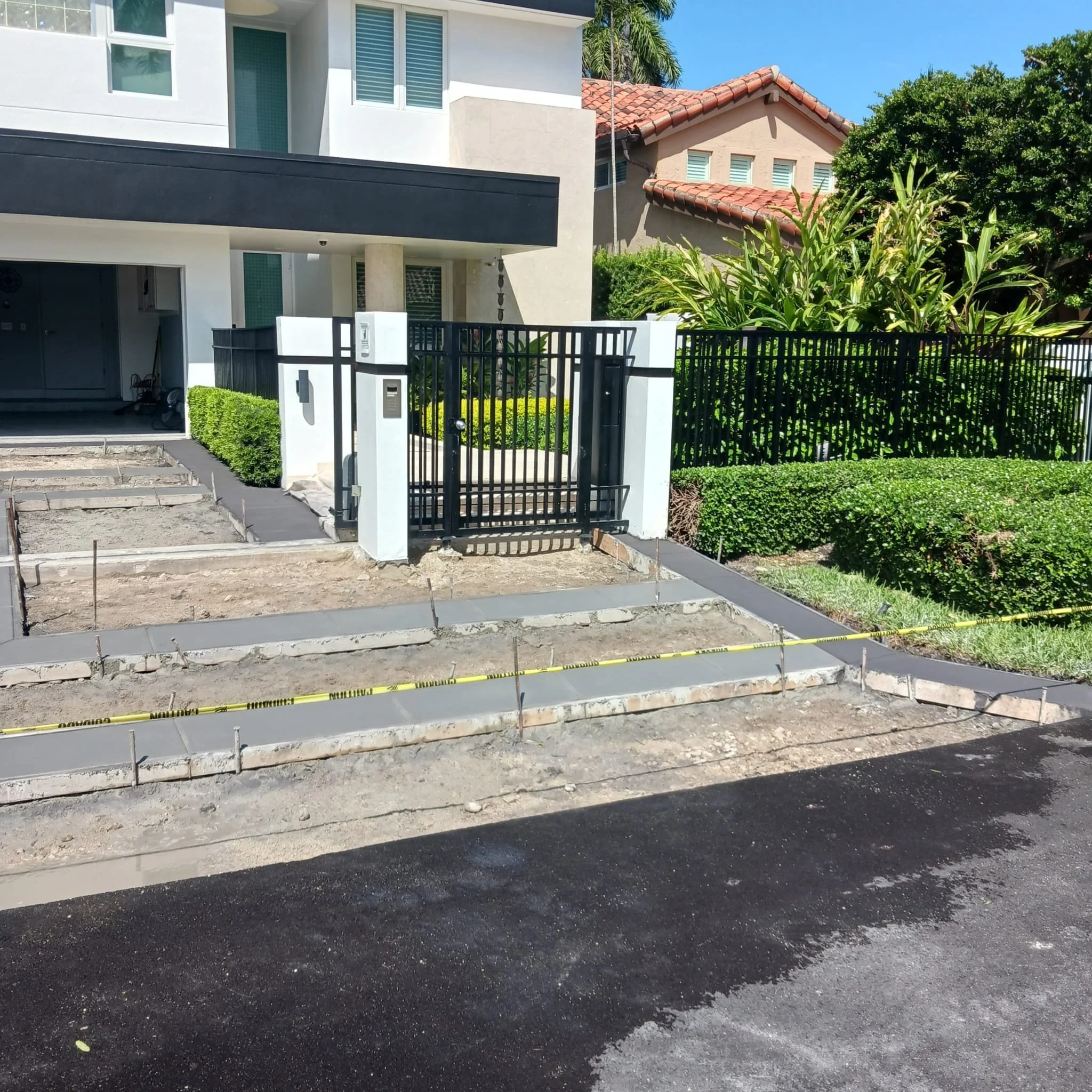 Modern house with a front gate and under-construction pathway