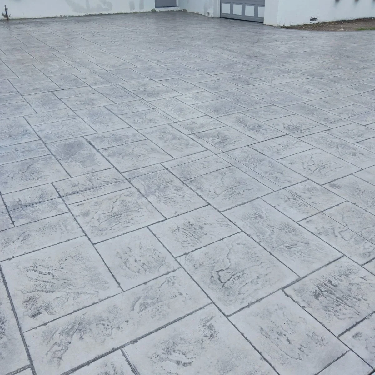 Patterned concrete driveway with square tiles