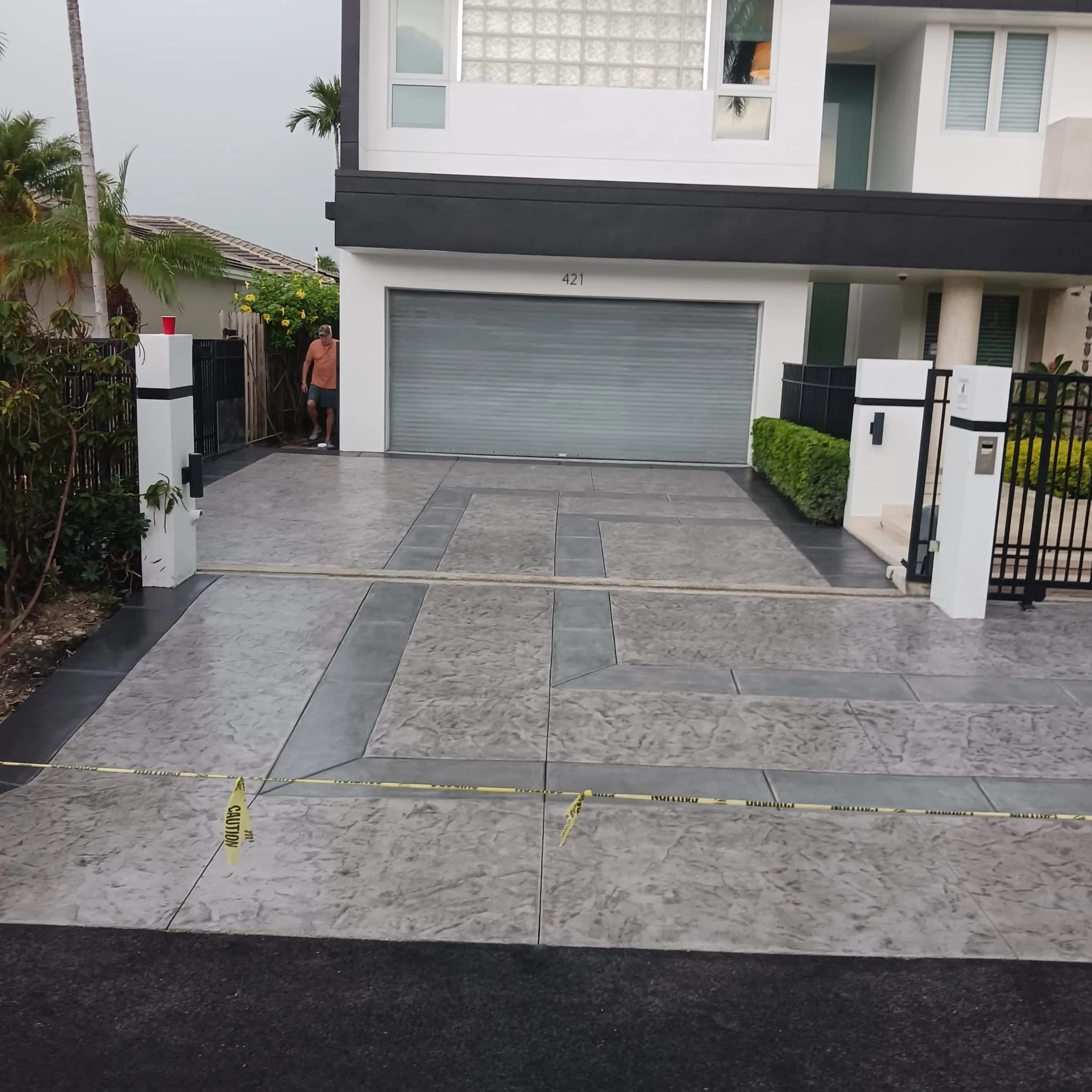 Decorative stamped concrete driveway with grey ribbons of art work.