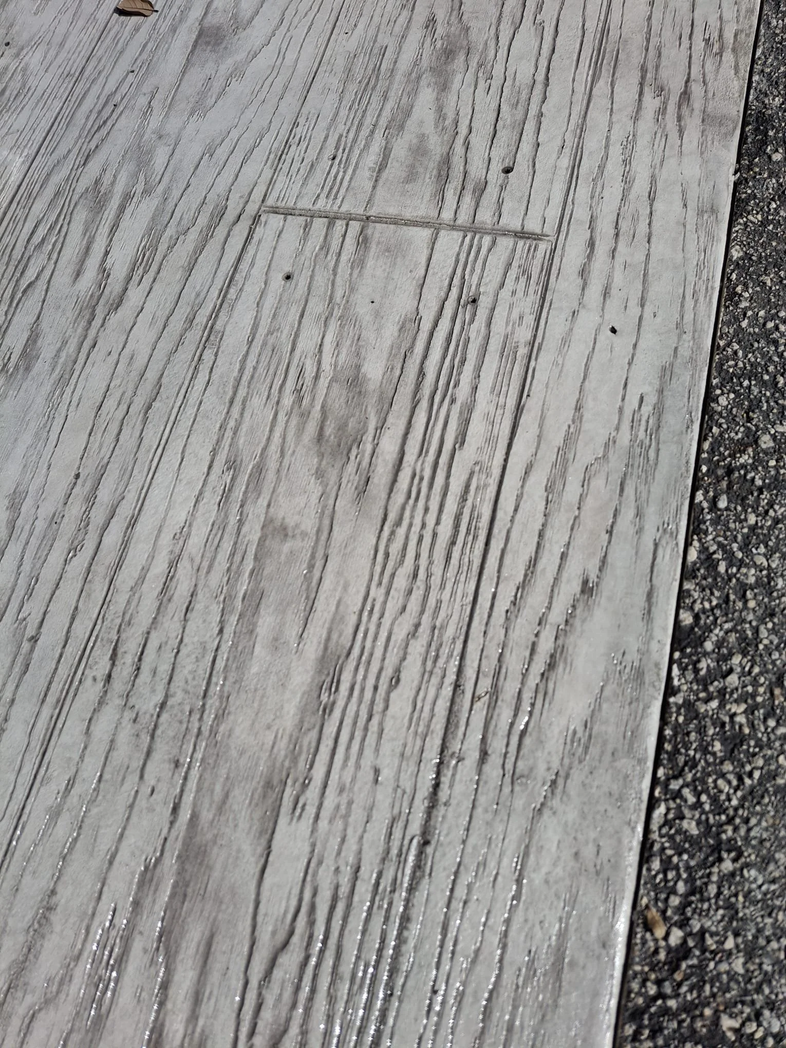 Textured concrete surface resembling wood planks