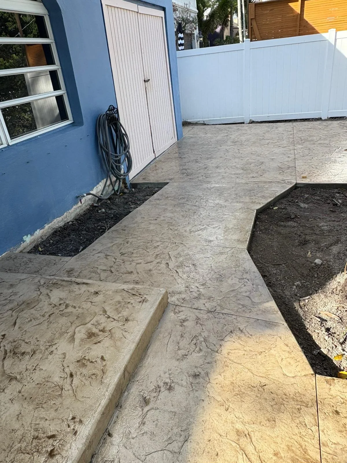 Outdoor decorative colored concrete patio with stamped texture.