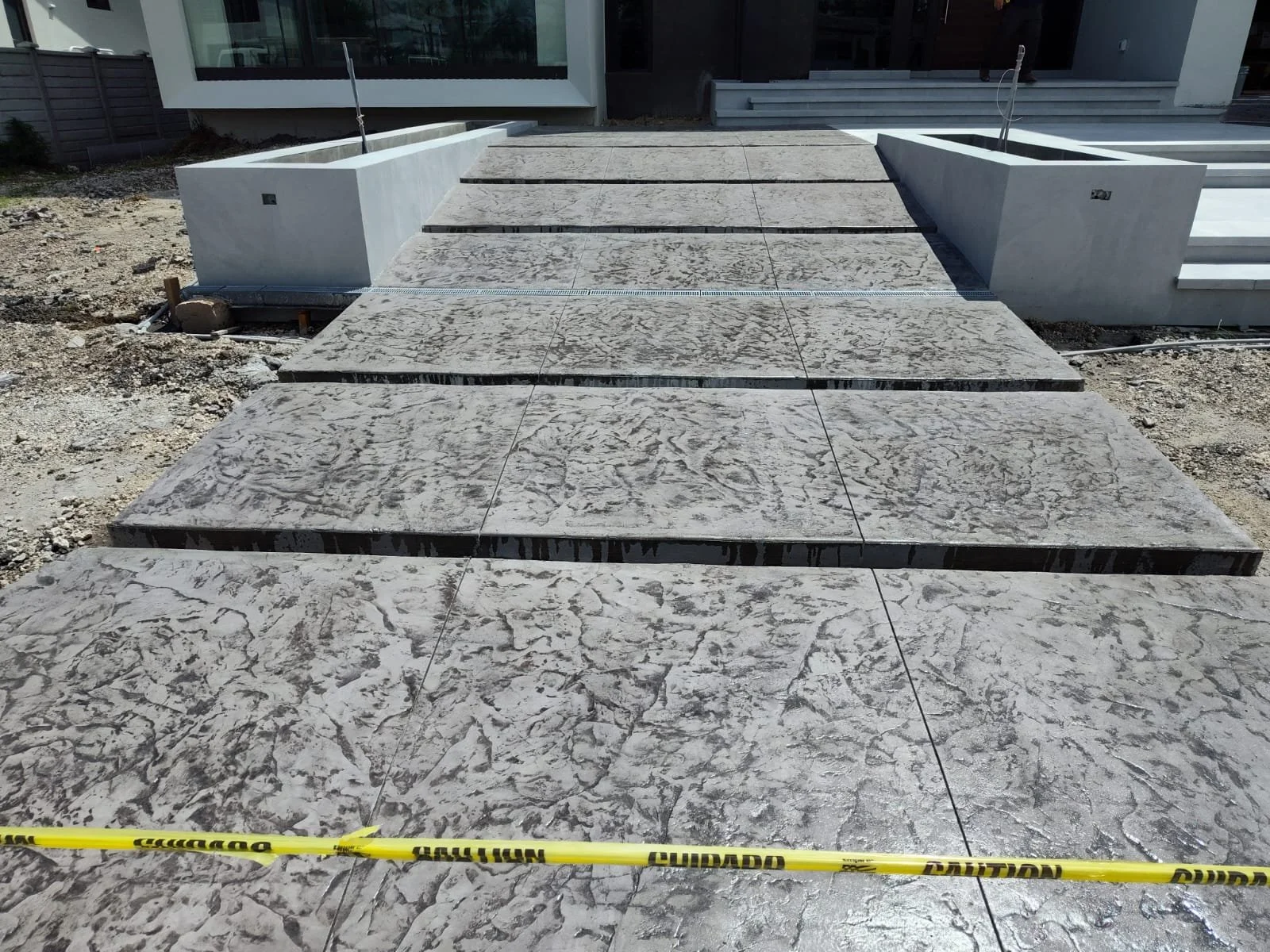 Concrete path under construction with caution tape