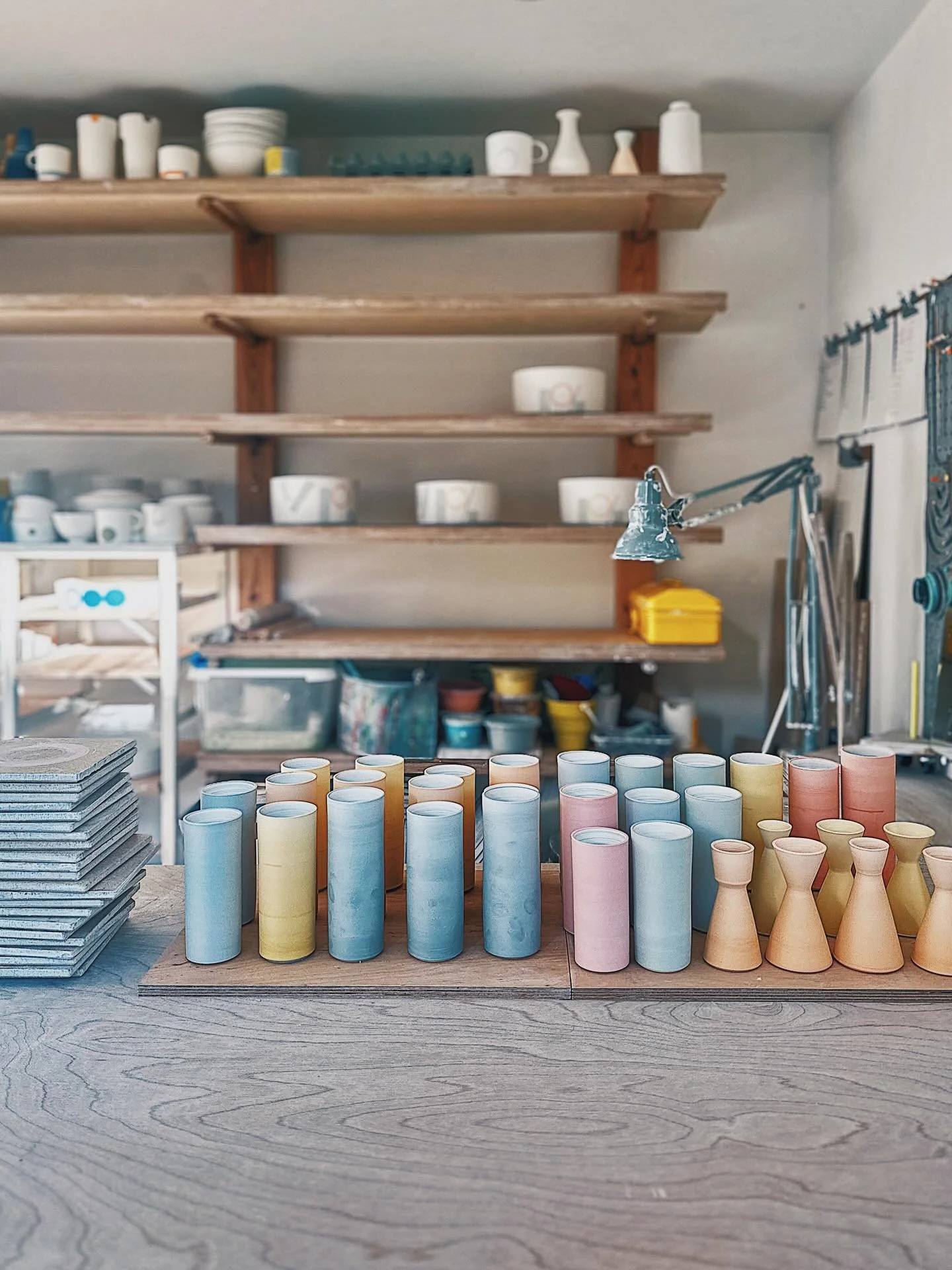 Porcelain slip cylinder and mini vases in progress, thrown, turned and slipped on bats before removing and then turning their bases. Slowly drying now awaiting their turn in the kiln for their first (bisc) firing 
.
.
.
.
.
 #wheelthrown #porcelain #