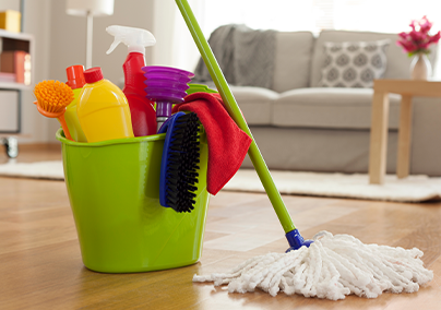 Canva - Plastic bucket with cleaning supplies in home.png