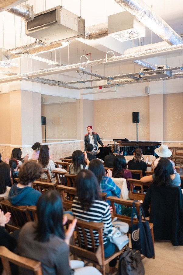 The Mollusc Dimension stands by the piano after a stand-up, screening and interactive music performance at besea.n's "Celebrating You" for ESEA (East and Southeast Asian) Heritage Month at China Exchange in September 2022.