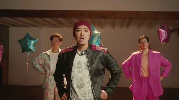 3 people are standing in a room with their hands on their hips. They look like they're in a pop band mid-choreography.