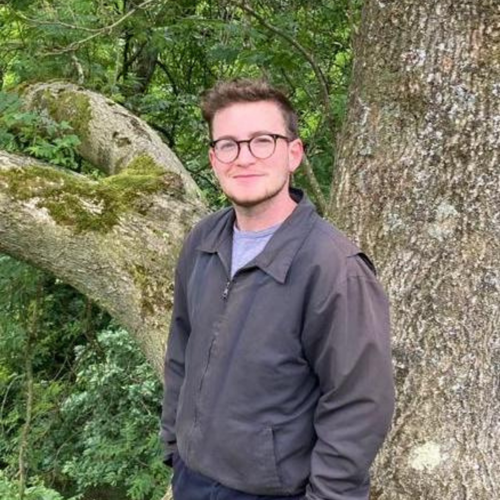 Moss, a man with short dark hair and glasses