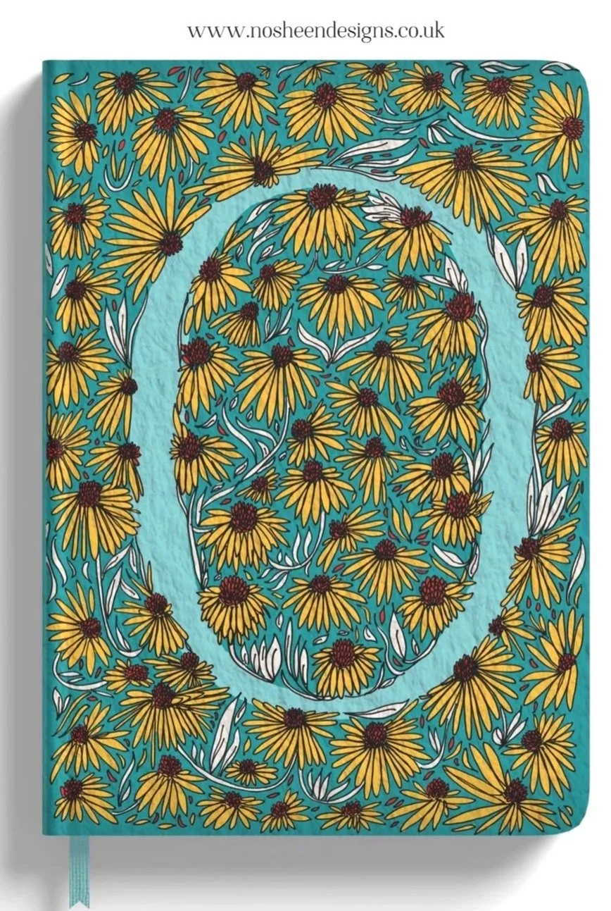 A notebook cover with a teal background featuring yellow daisies and white leaves, with a spiral outline of daisies in the center.