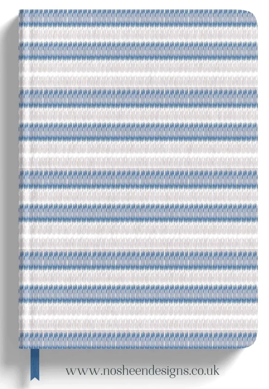 A fabric with horizontal blue and white stripes and a small blue ribbon tab at the bottom, with a website URL www.nosheendesigns.co.uk at the bottom.
