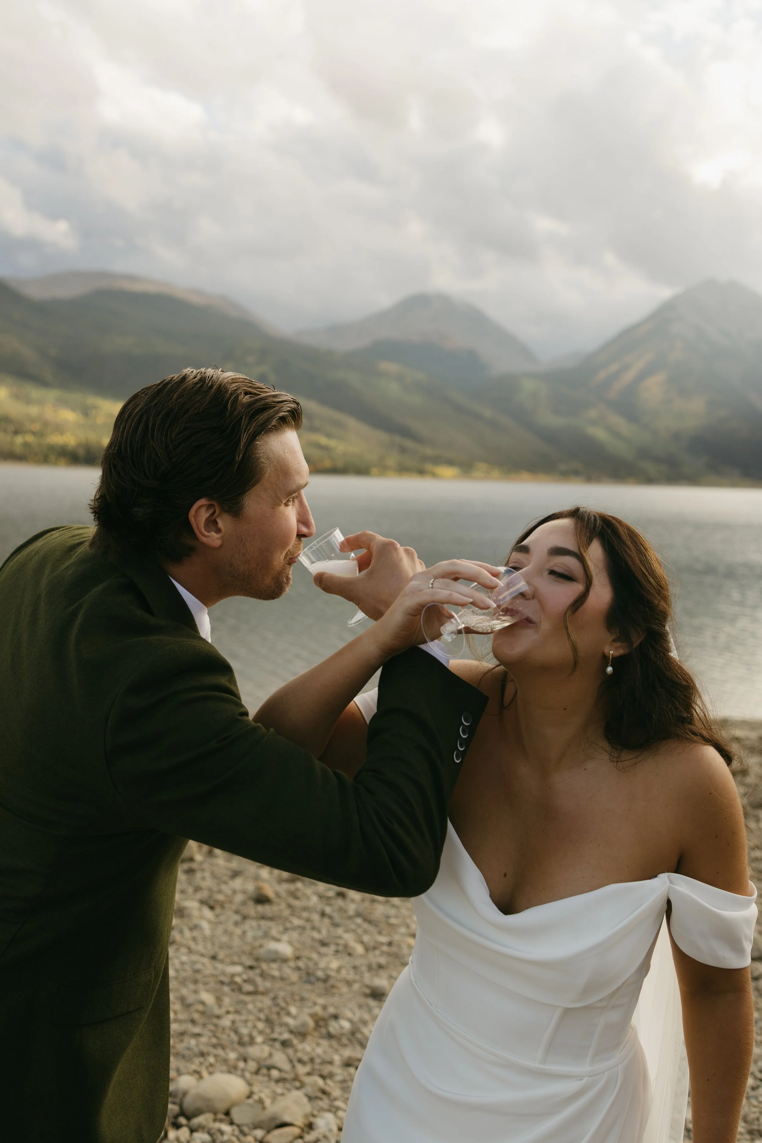 a bride and groom drinking champange post elopement ceremony in twin lakes, colorado