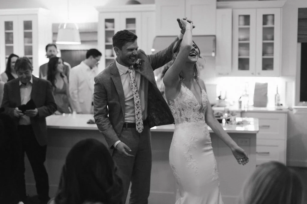 Bride and groom enjoy their first dance as husband and wife in the middle of the kitchen following their surprise wedding.