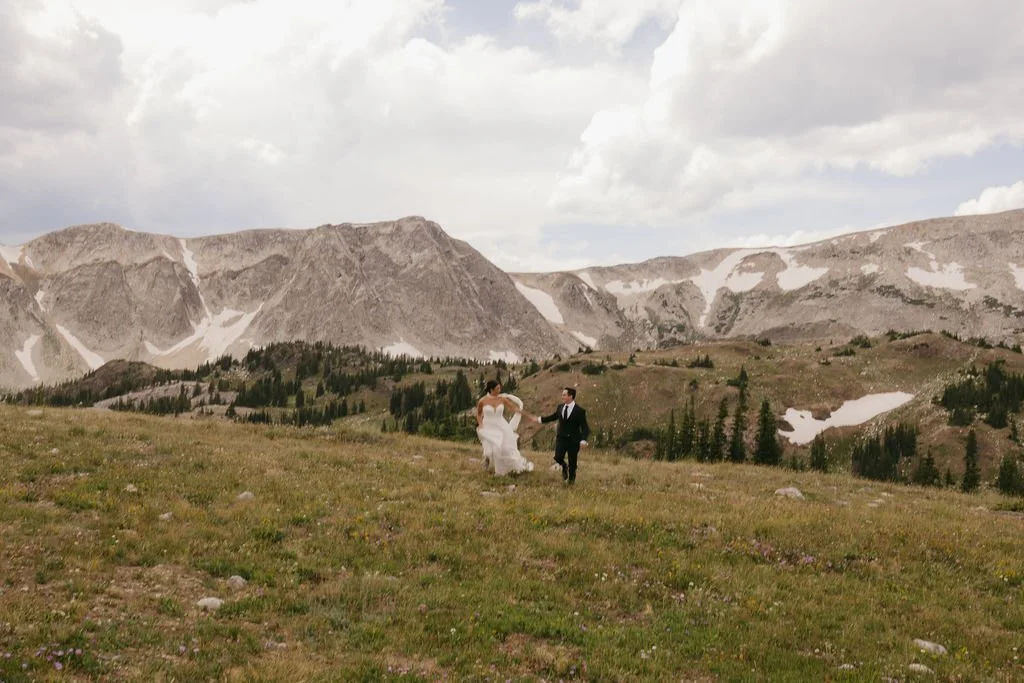 Bride and groom frolic in Snowy Range after exchanging private vows.