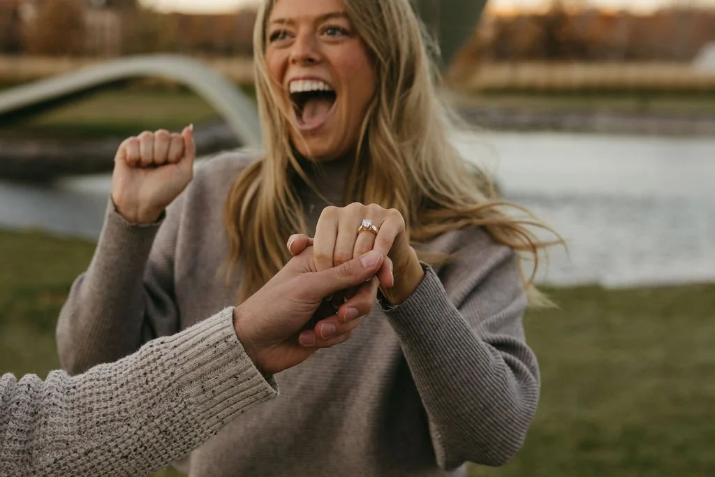 a woman shows off her new engagement ring following a surprise proposal