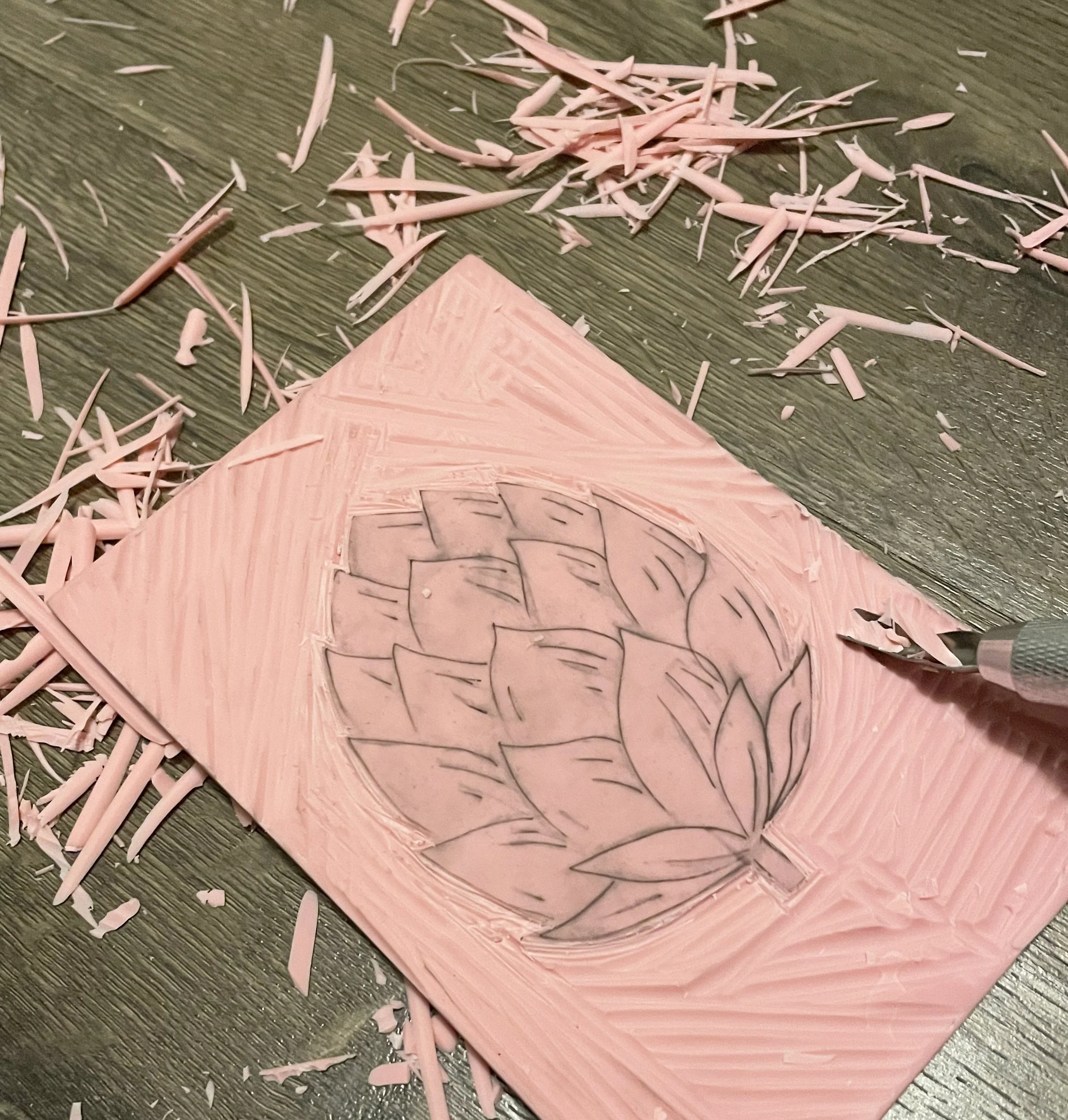 Carving process in linoleum to make prints of a beer hop. 