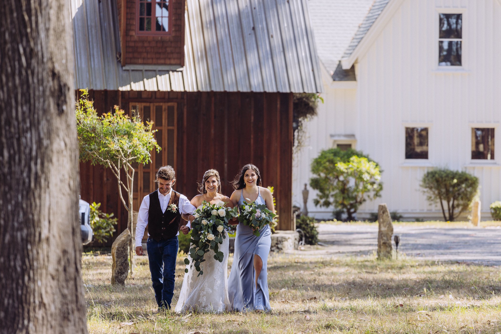 Bride and friends walking down outdoor aisle at Spring Ranch, in Mendocino, Calfiornia