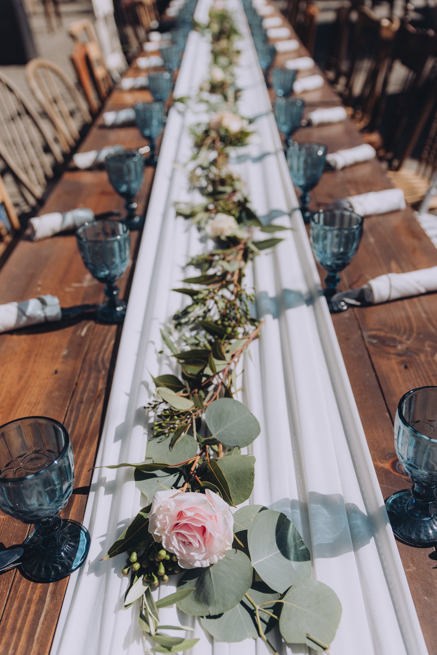 Wedding reception table decor with roses and leaves on table at Spring Ranch, in Mendocino, Calfiornia