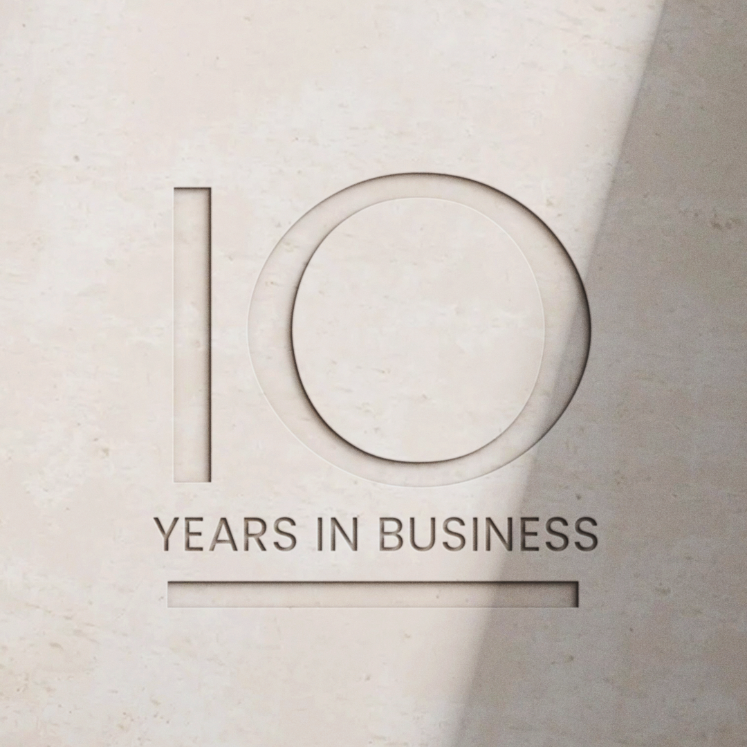 Embossed plaque celebrating 10 years in business, with the number 10 prominently displayed.