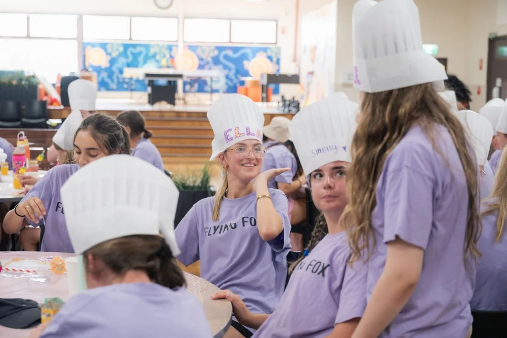 Young women in purple t-shirts for Flying Fox in ANZAC Hall Urban Camp.