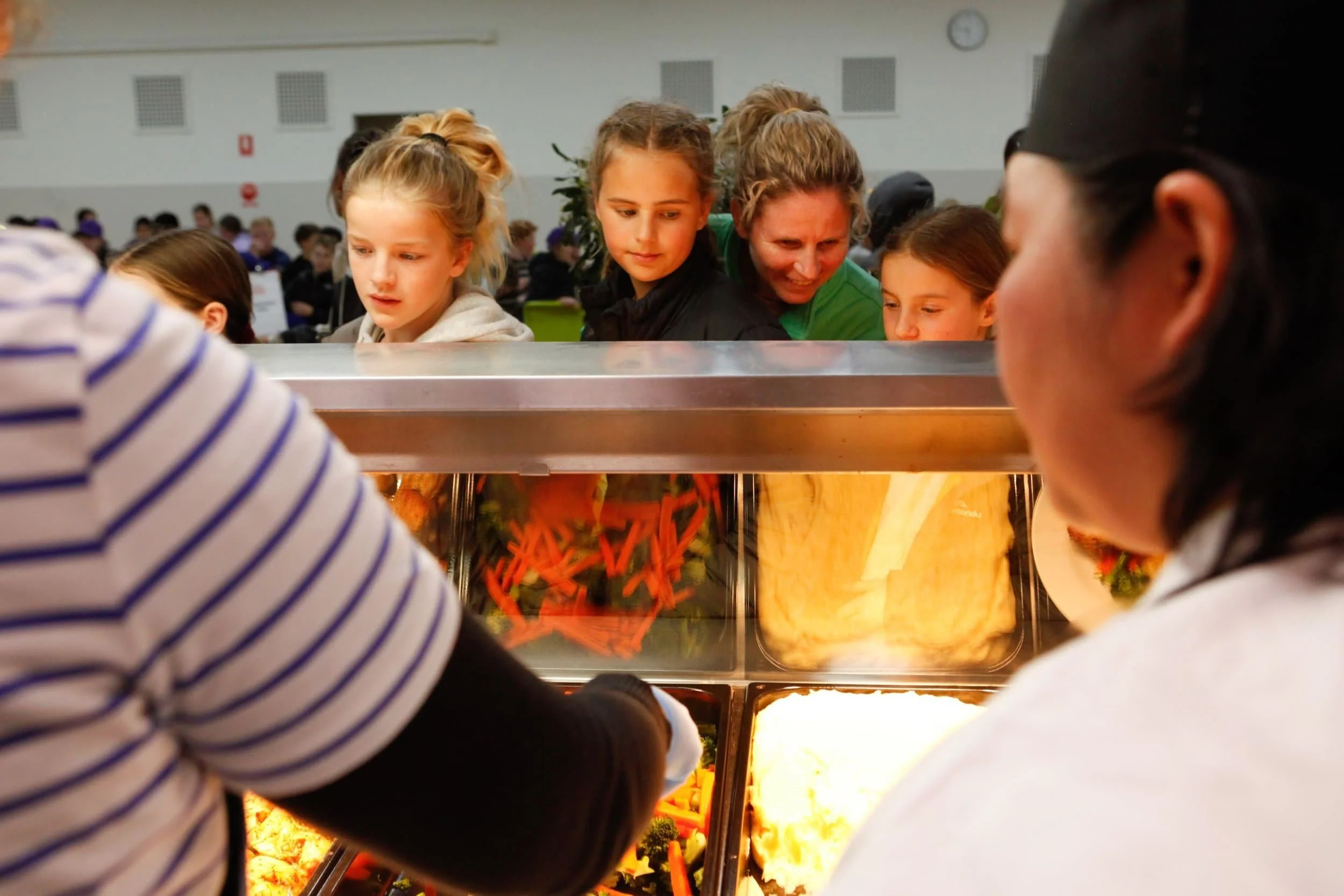 Kids lining up for dinner at Urban Camp