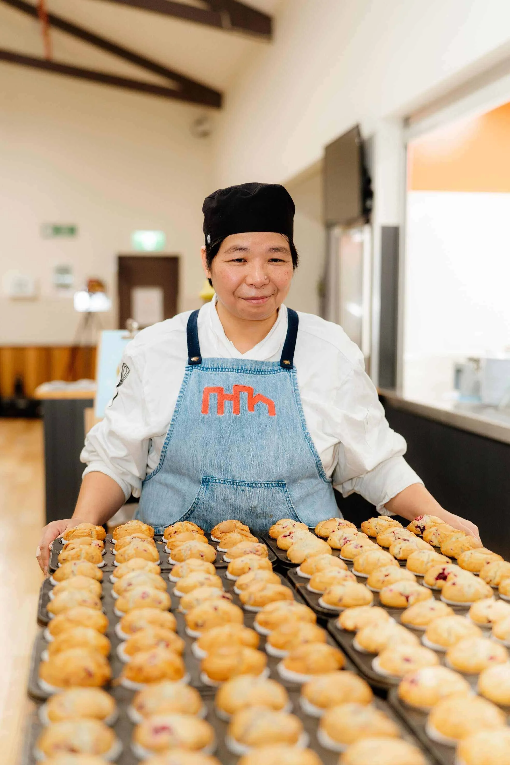 Chef with tray of muffins ready for kids at Urban Camp.
