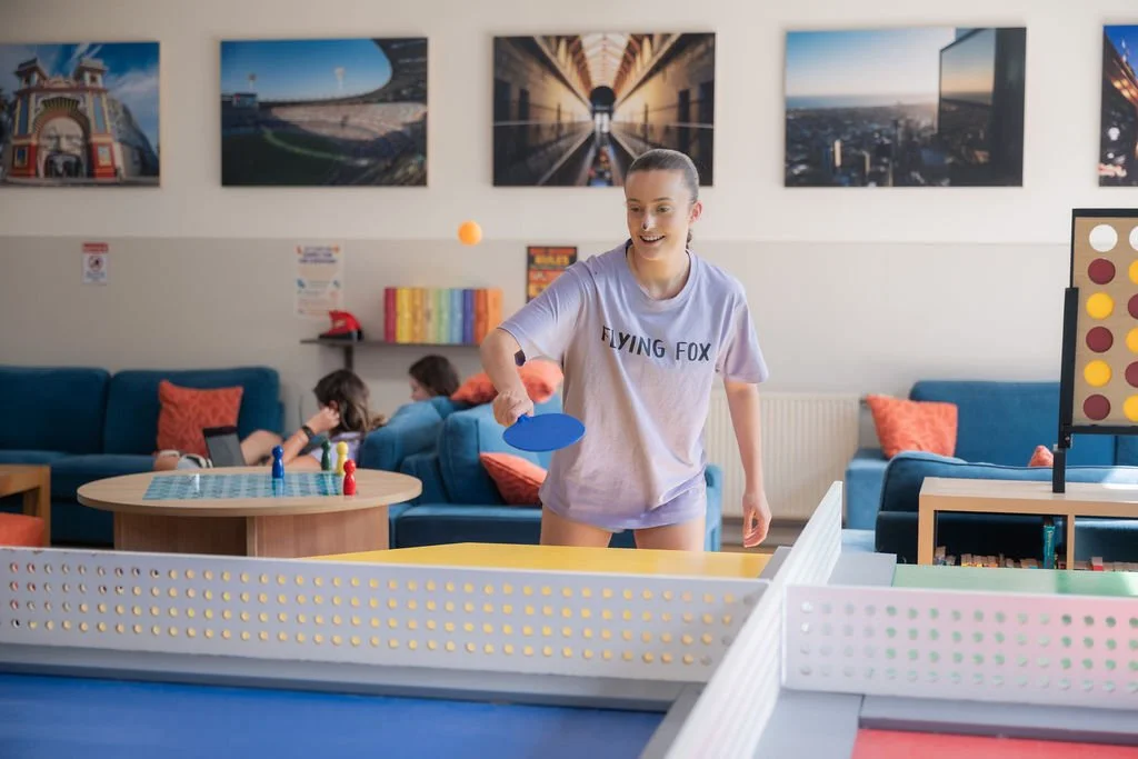 Young adult from Flying Fox playing table tennis at Urban Camp