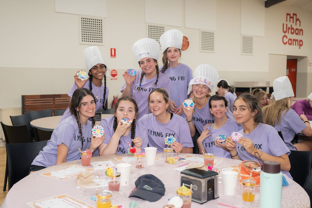 Group of young women showing decorated cookies at Urban Camp